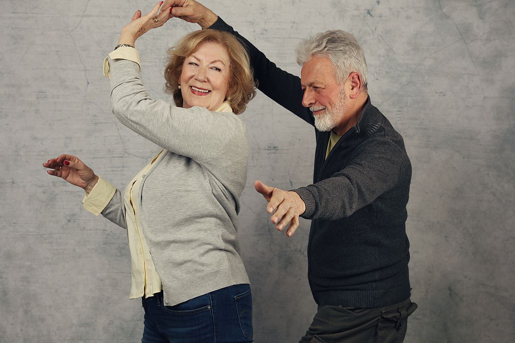  Happy stylish elderly couple dancing and laughing. Vintage image